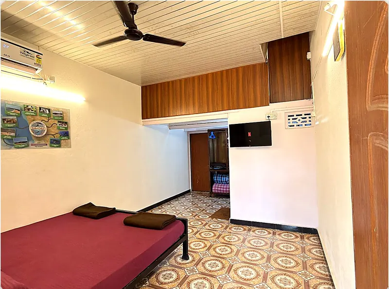 Room 3 king bed and wall map of Konkan